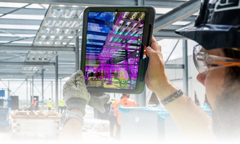 Construction worker using GAMMA AR on tablet.