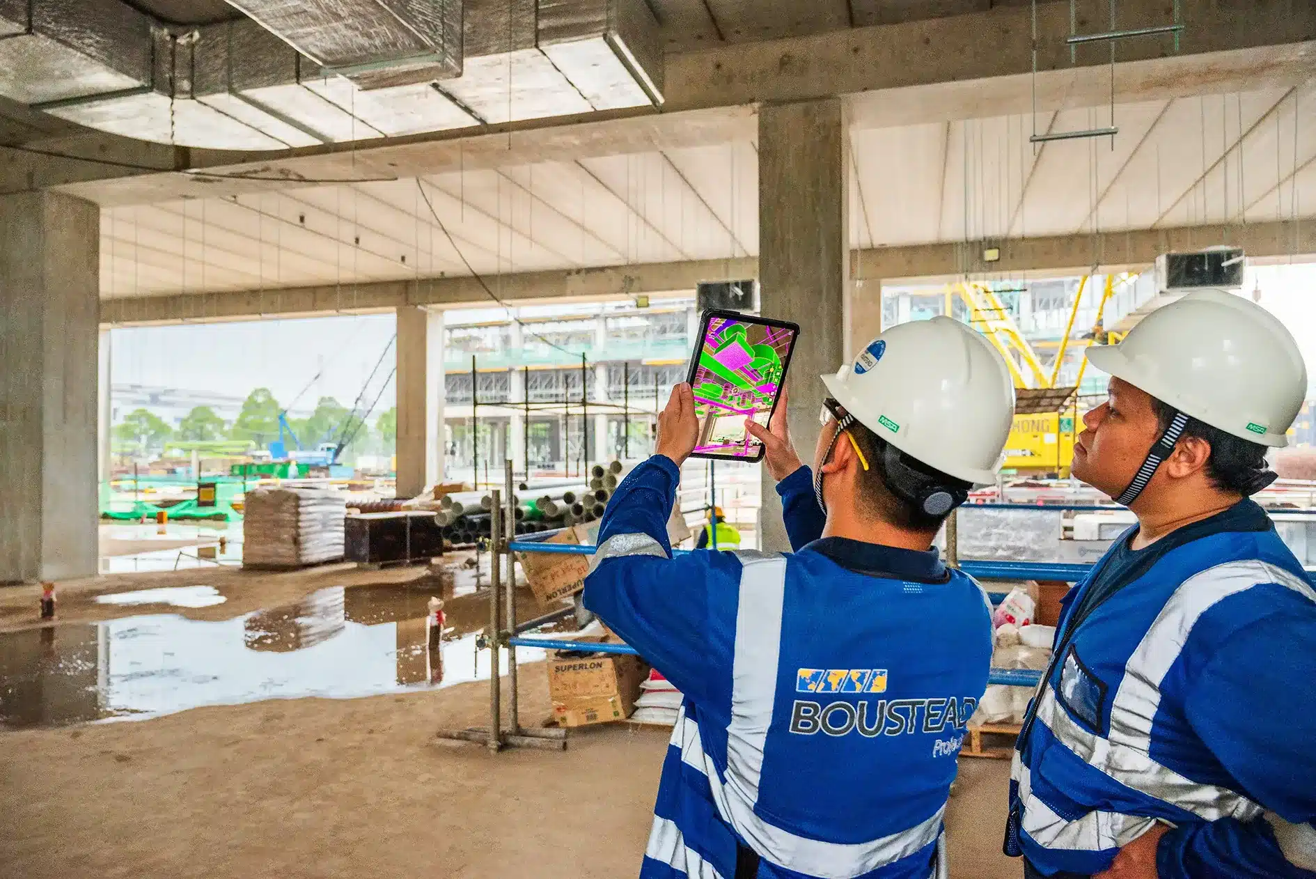 Site engineers checking a BIM model overlay in GAMMA AR inside a concrete structure